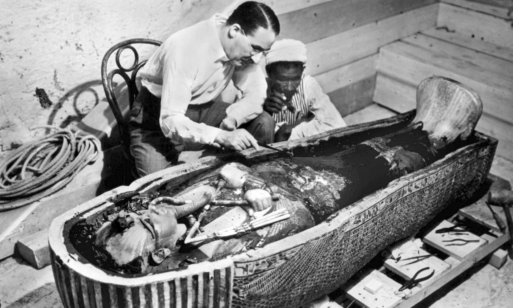 Howard Carter examines the sarcophagus of Tutankhamun